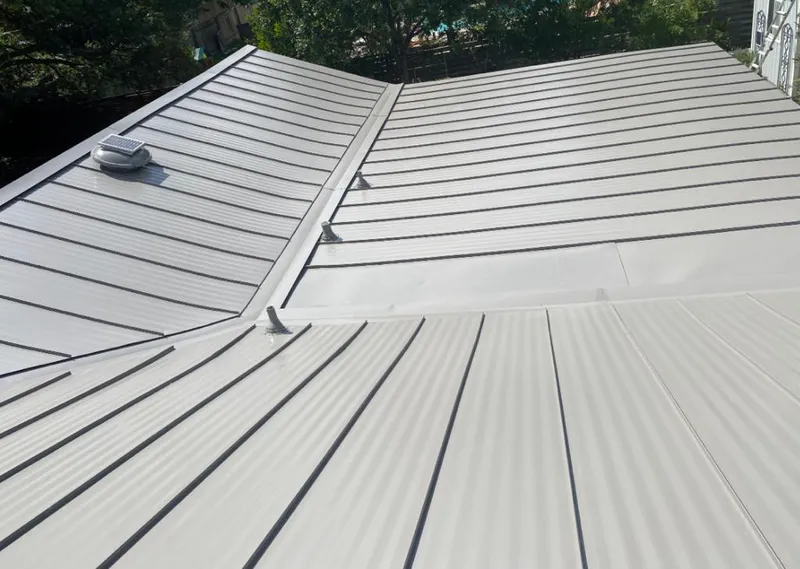 Solar attic fan installed on a metal roof for Roof Ventilation in Columbine